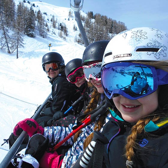 Students on a chair lift in the mountains